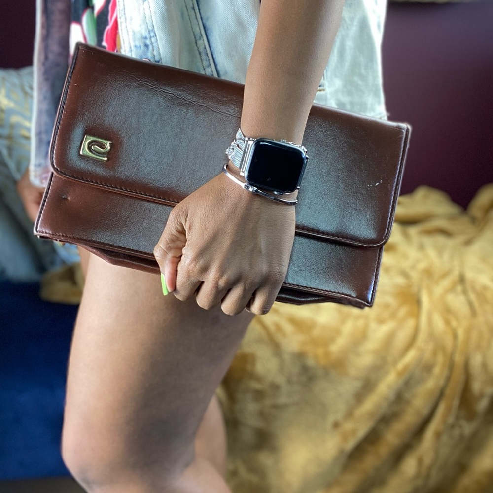 Brown Handheld Purse with some minor flaws.
